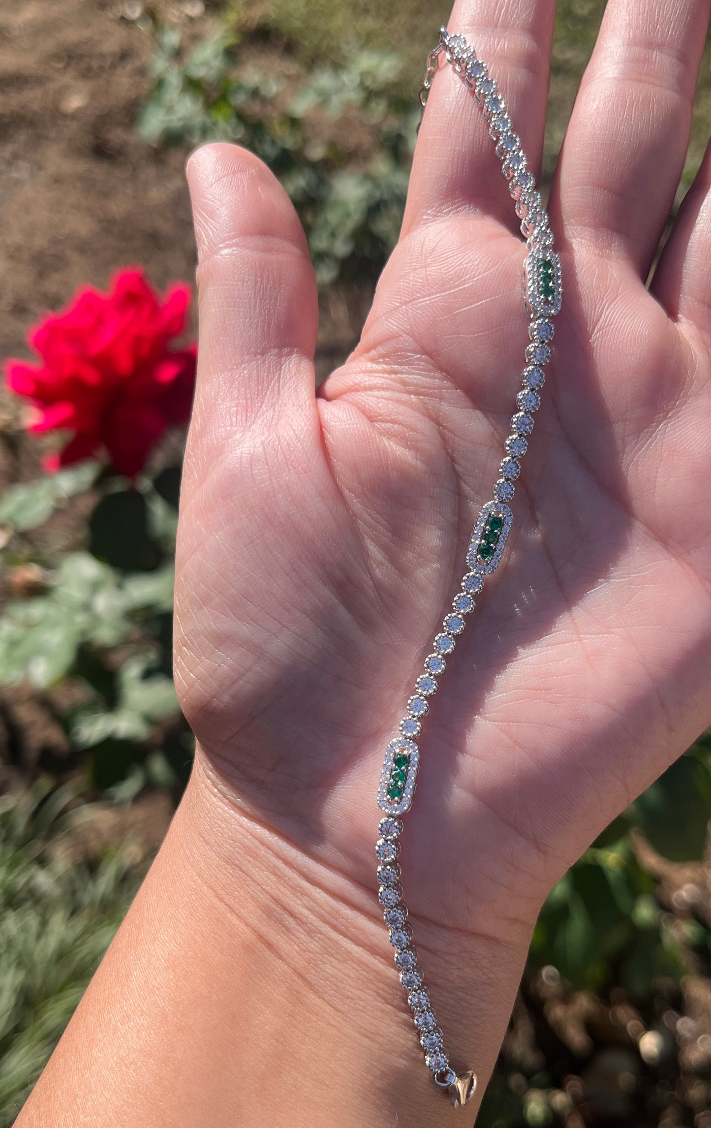 Tennis bracelet with rectangle design and green cz stones