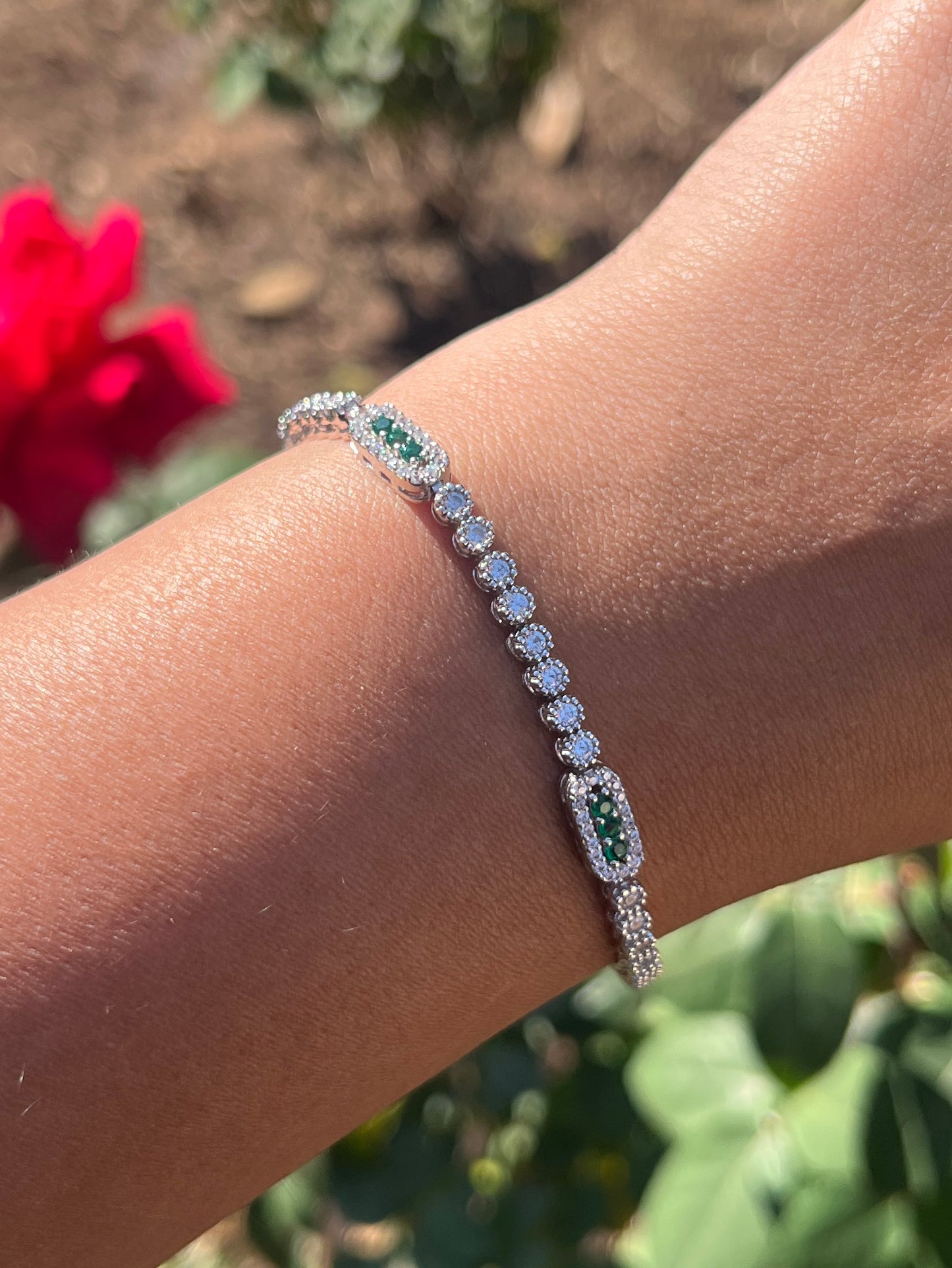 Tennis bracelet with rectangle design and green cz stones