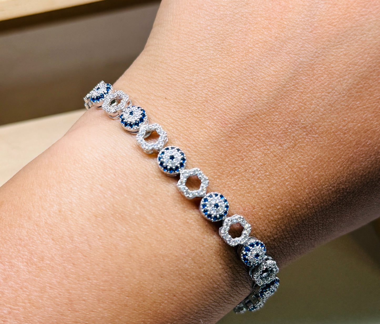 Evil eye tennis bracelet - Alternating eye and open flower design